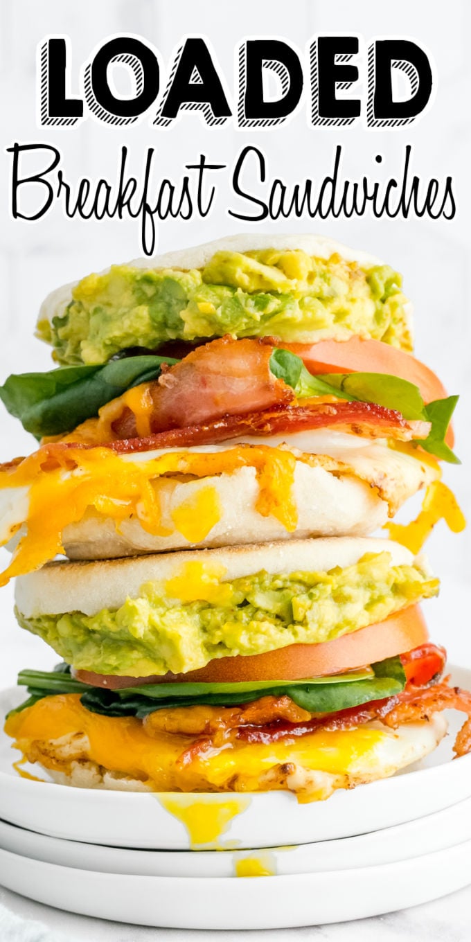 These Loaded Breakfast Sandwiches have eggs, bacon, cheese, avocado, spinach, and tomato. This recipe has freezer instructions, too! via @foodfolksandfun