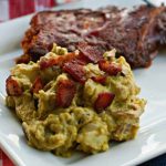 Bacon and Avocado Potato salad on a plate with bacon pieces on top