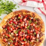 Sprinkle the pizza with chopped strawberries and cilantro.