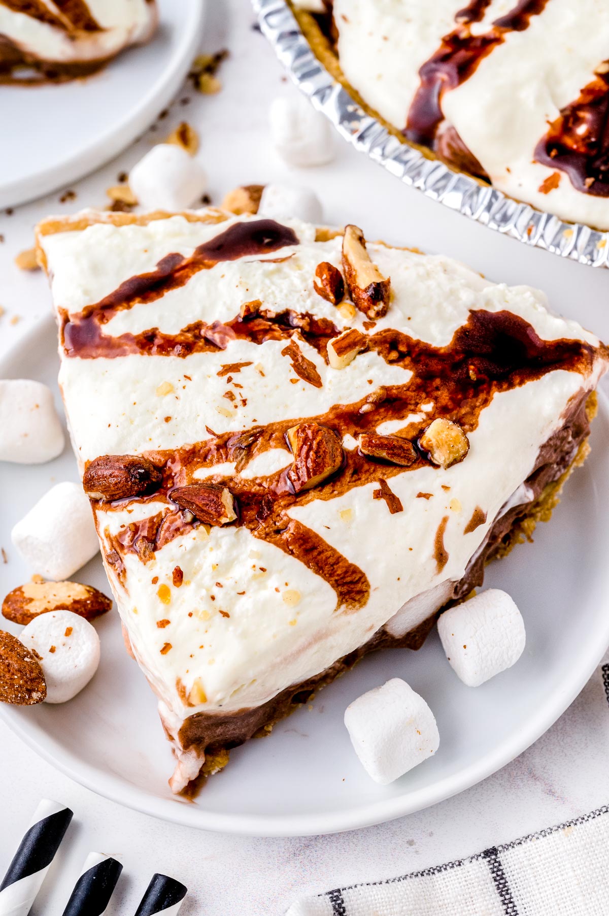 A slice of the finished Rocky Road Pie recipe on a white plate.
