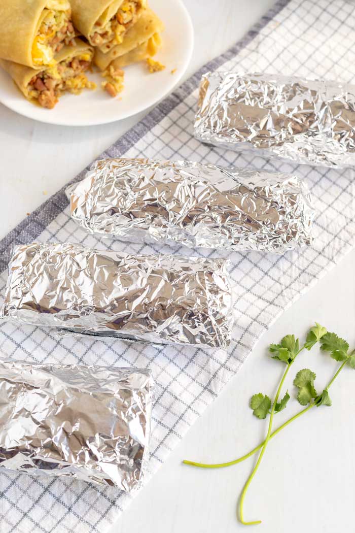 Breakfast Burritos wrapped in foil and ready to be frozen.