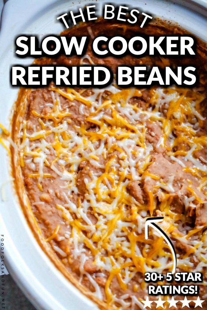 Finished refried beans inside of a crock pot with text overlay for Pinterest.