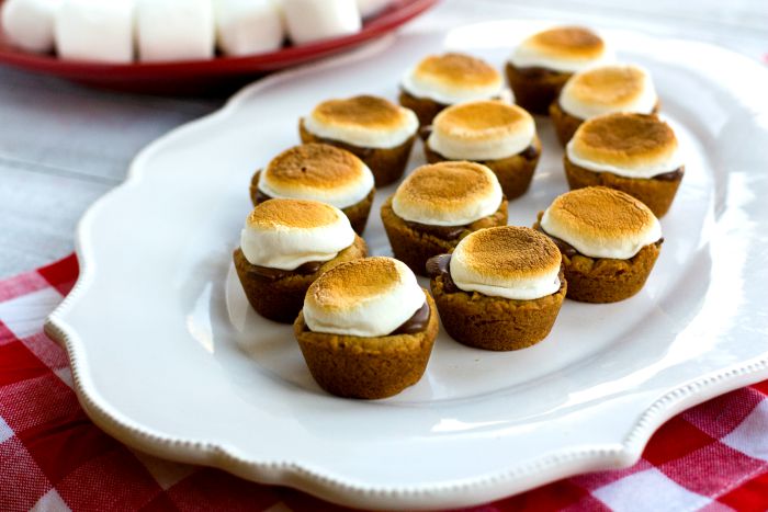 S'mores Cookie Bites  on a serving platter with marshmallows in the background