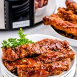 The crockpot spare ribs after they are done cooking with barbecue sauce on them.