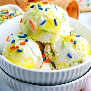 A close up picture of three scoops of Funfetti Cake Batter Ice Cream.