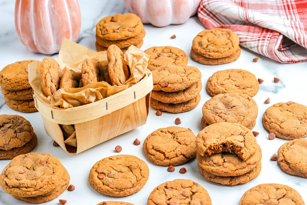Cokies on a table top and some in a little basket.
