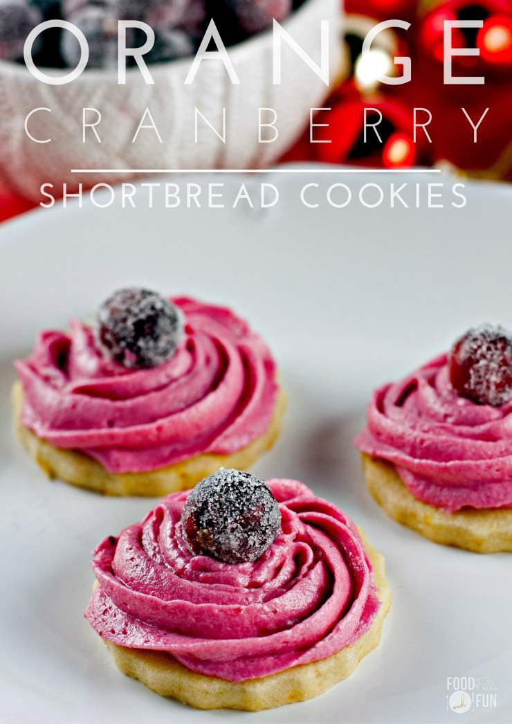 3 Orange shortbread cookies with cranberry frosting on a plate. 