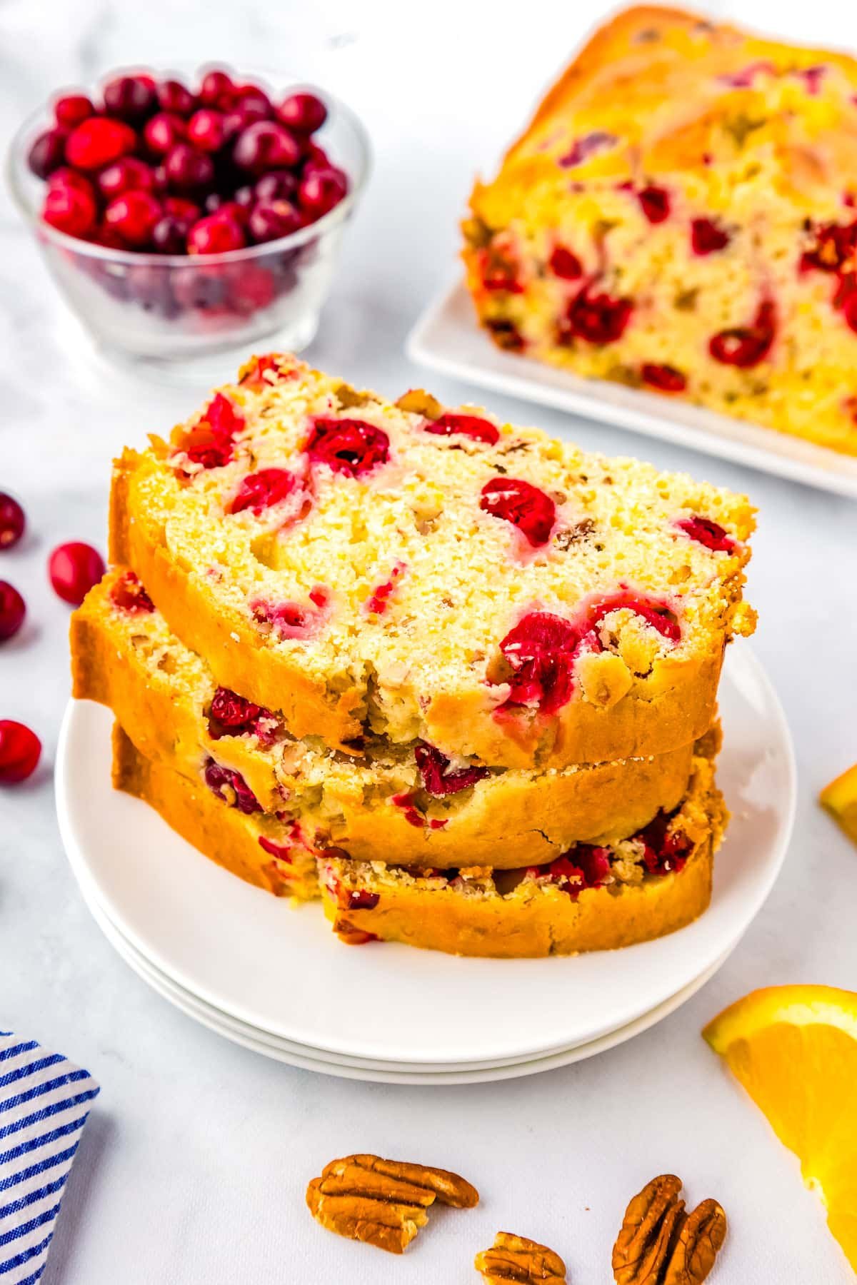 Three slices of Cranberry Orange Bread on a plate. 