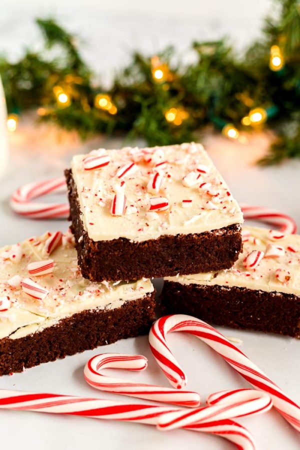 Peppermint brownies surrounded by candy canes. 