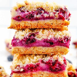 close up picture of three Blueberry Crumble Bars stacked on each other.