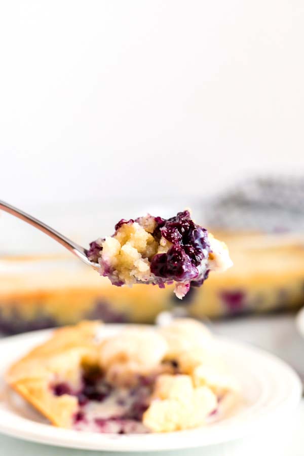 A spoon full of blueberry cobbler.