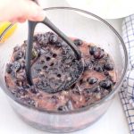 Smash the blueberries with a potato masher.