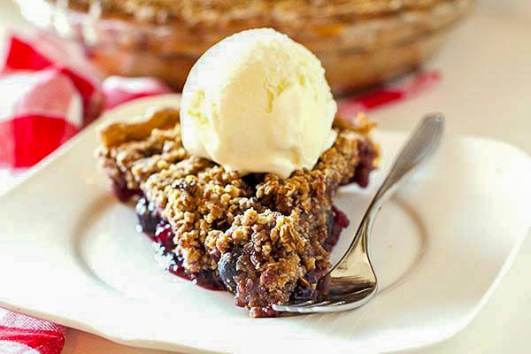 Cherry pie on a white plate with a fork 