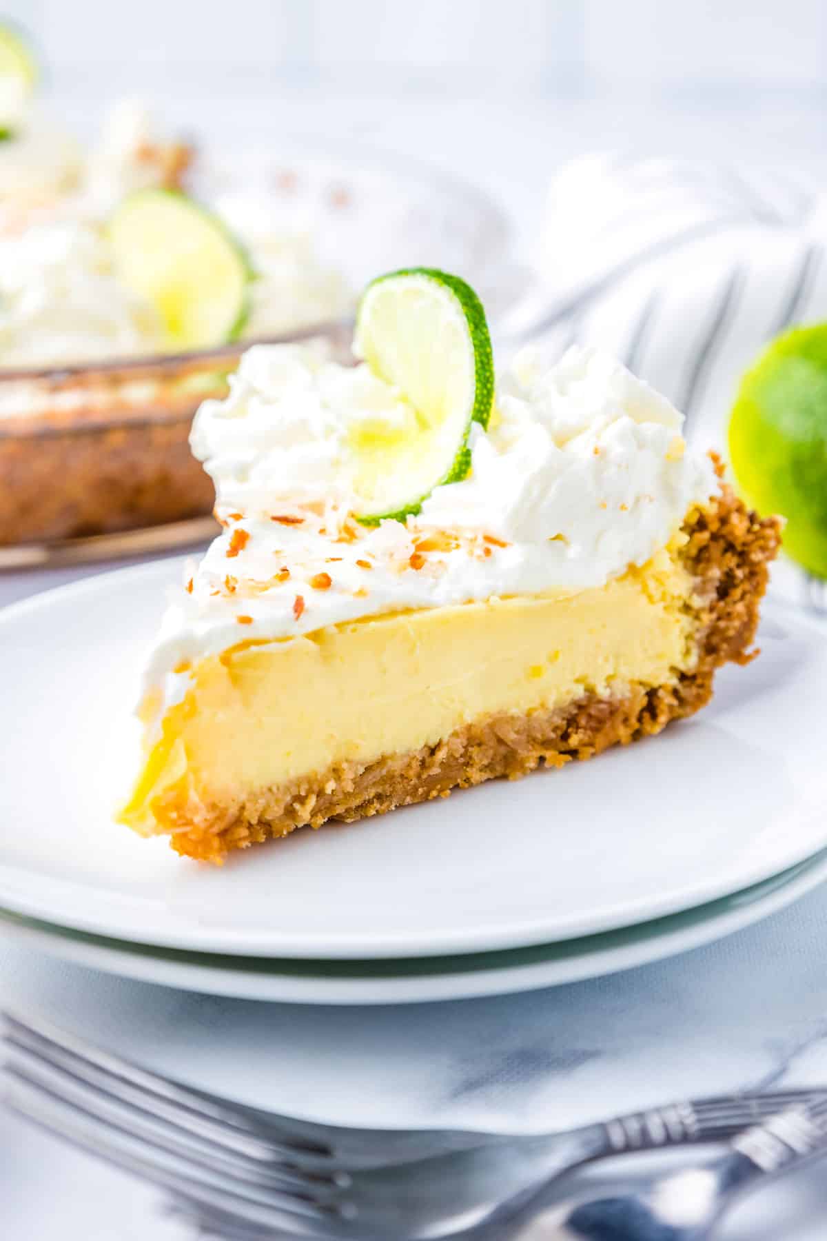 A slice of Key Lime Pie on a white plate.