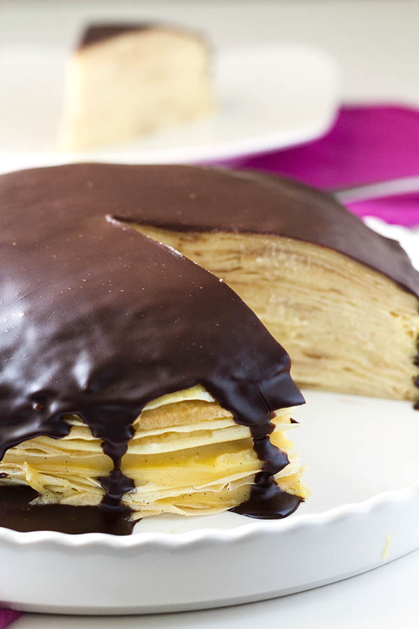 This Boston Cream Pie Crepe Cake has layers of sweet crepes between layers of silky pastry cream that’s topped with a smooth chocolate glaze. via @foodfolksandfun
