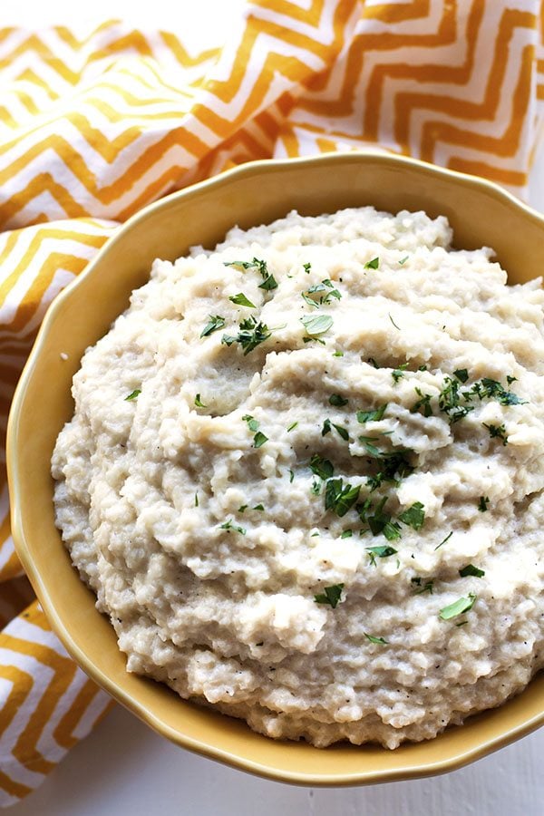 This Healthy Mashed Cauliflower recipe is delicious, flavorful and low-carb! You can get this mashed cauliflower on the table in 20 minutes or less!
