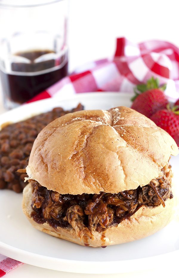Root beer pulled pork on a bun on a plate