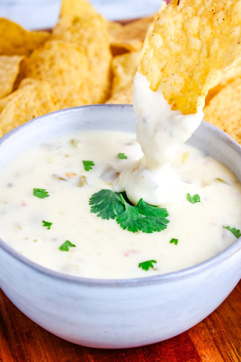 Creamy white queso dip served warm with tortilla chips.