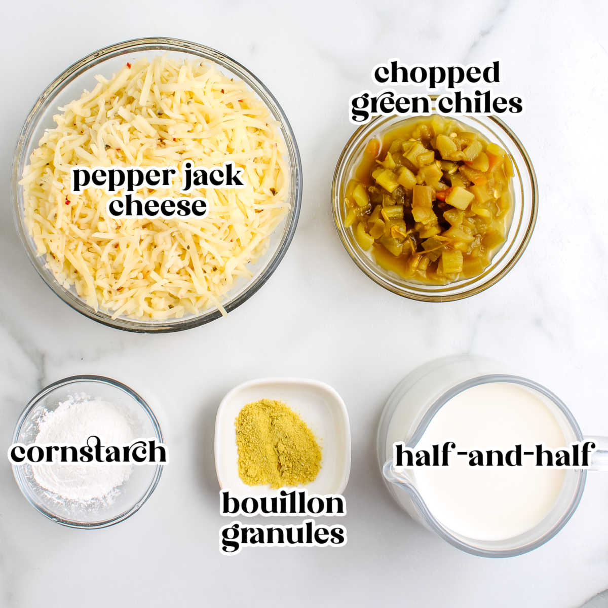 ngredients for green chile queso dip arranged on a white surface.