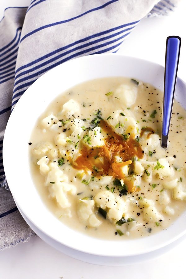 This Creamy Cauliflower Soup recipe is savory, cheesy, and filled with tender chunks of cauliflower plus all of the comforts of a home-cooked meal!