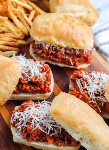 Four sloppy joes on a serving board.