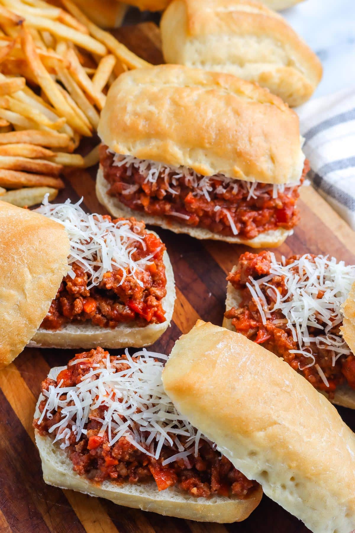 Four sloppy joes on a serving board.