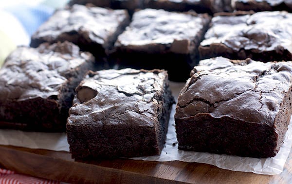 Cut brownies on a wooden tray. 