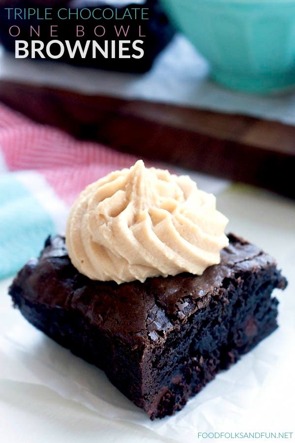 A brownie with a squeeze of peanut butter frosting on top. 