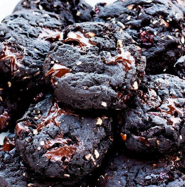 A close-up of a stack of Dark Chocolate Cherry Cookies with Almonds