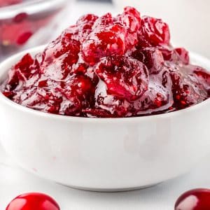 A close up of cranberry sauce in a small white bowl.