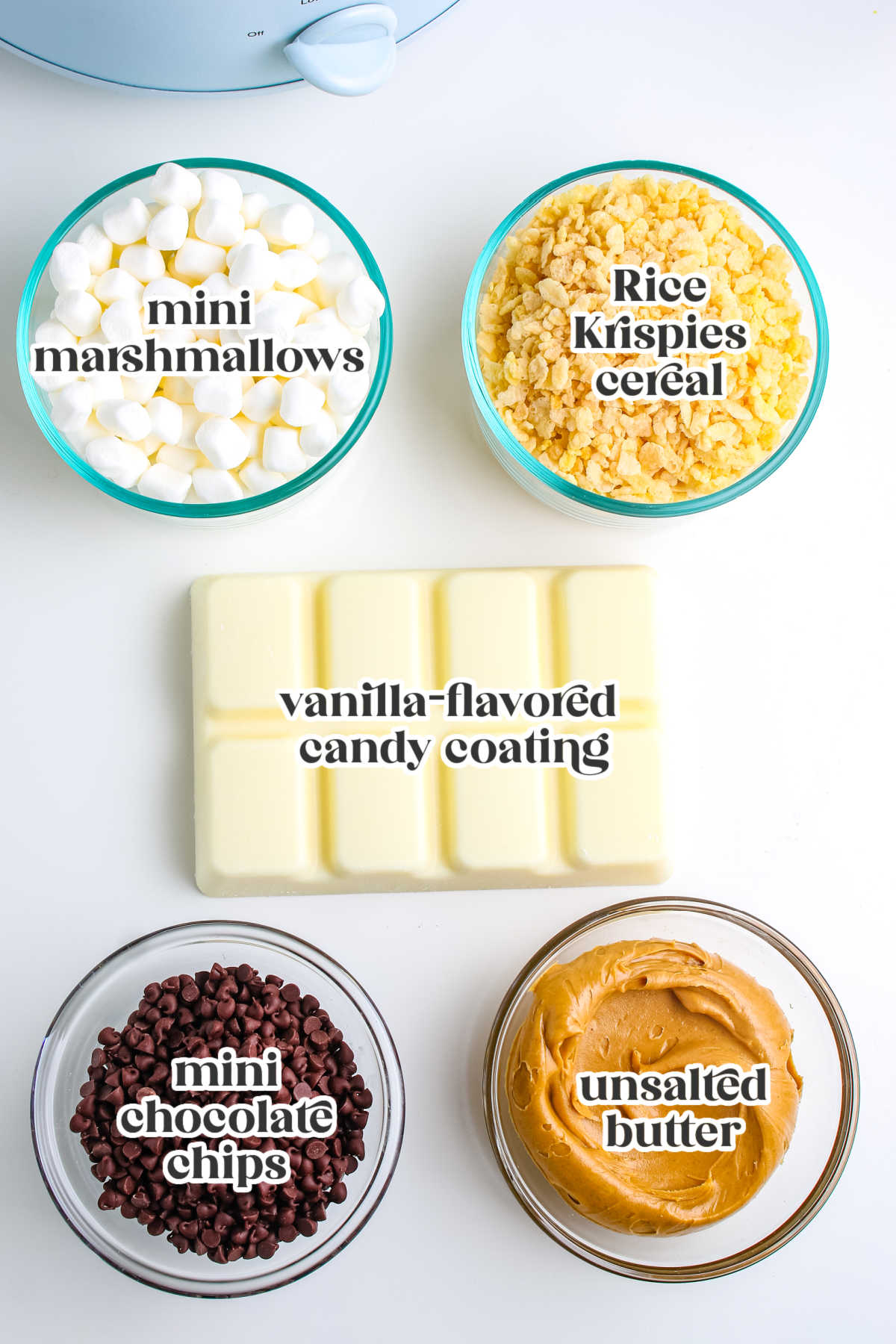 Labeled ingredient shot showing mini marshmallows, Rice Krispies cereal, vanilla flavored candy coating, mini chocolate chips, and creamy peanut butter.