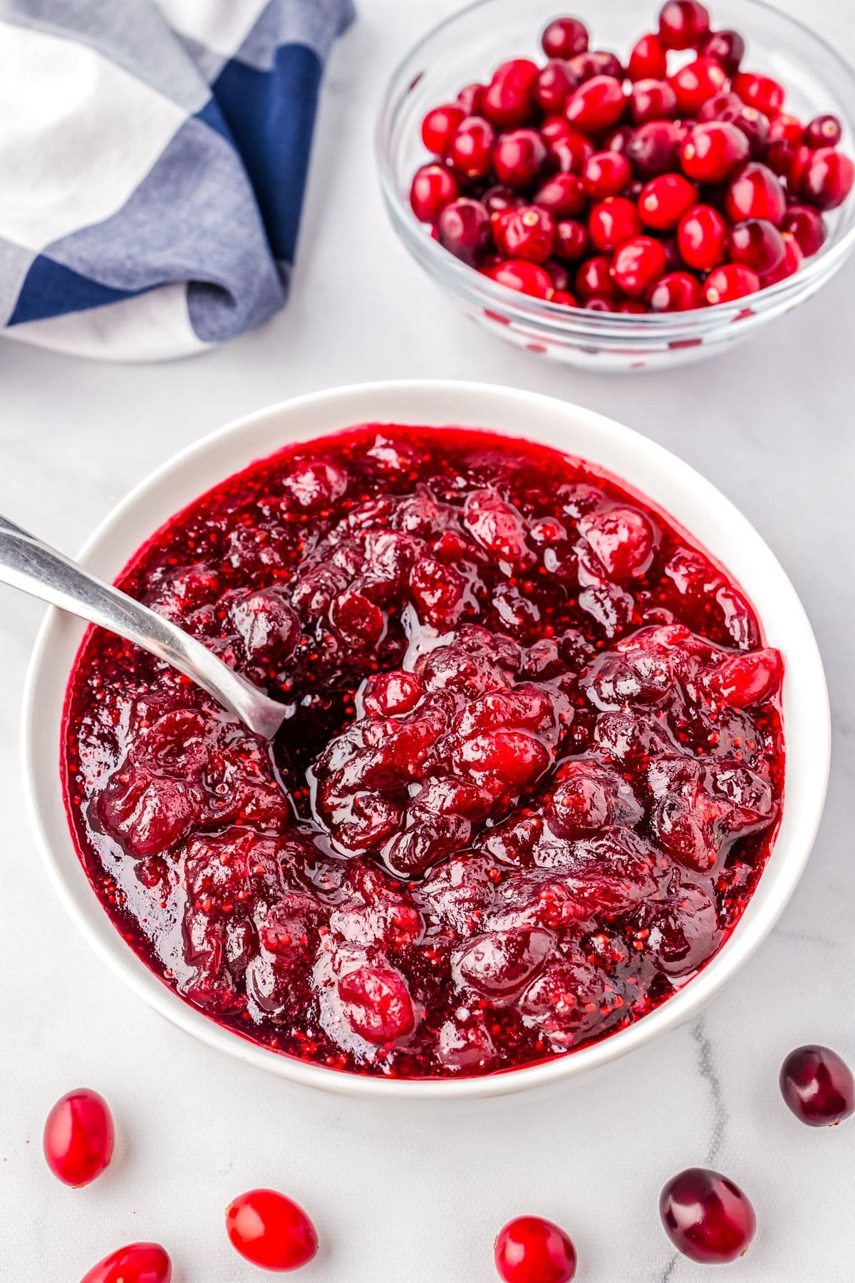 A spoon in a bowl of Simple Cranberry Sauce.