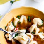 A spoonful of Tortellini Soup in a bowl