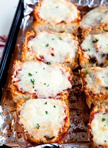 Two rows of French Bread Pizza on a baking sheet