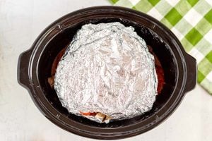 Place the veggies in a foil packet and place them on top of the beef inside of the slow cooker.