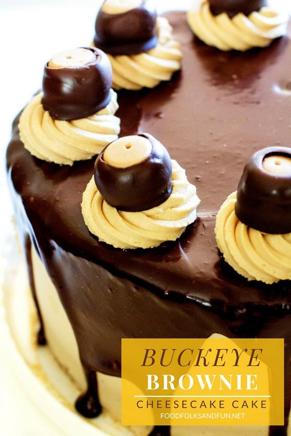 A close-up of Buckeye Brownie Cheesecake Cake on a plate with text overlay for Pinterest