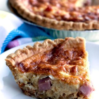 A close up of a slice of Ham and Cheese Quiche on a plate