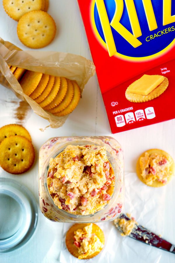 Pimento Cheese Dip in a container with crackers to dip in it