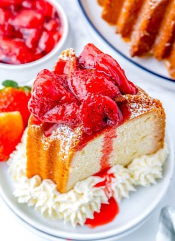 An overhead picture of a piece of Cream Cheese Pound Cake with strawberry topping on it.