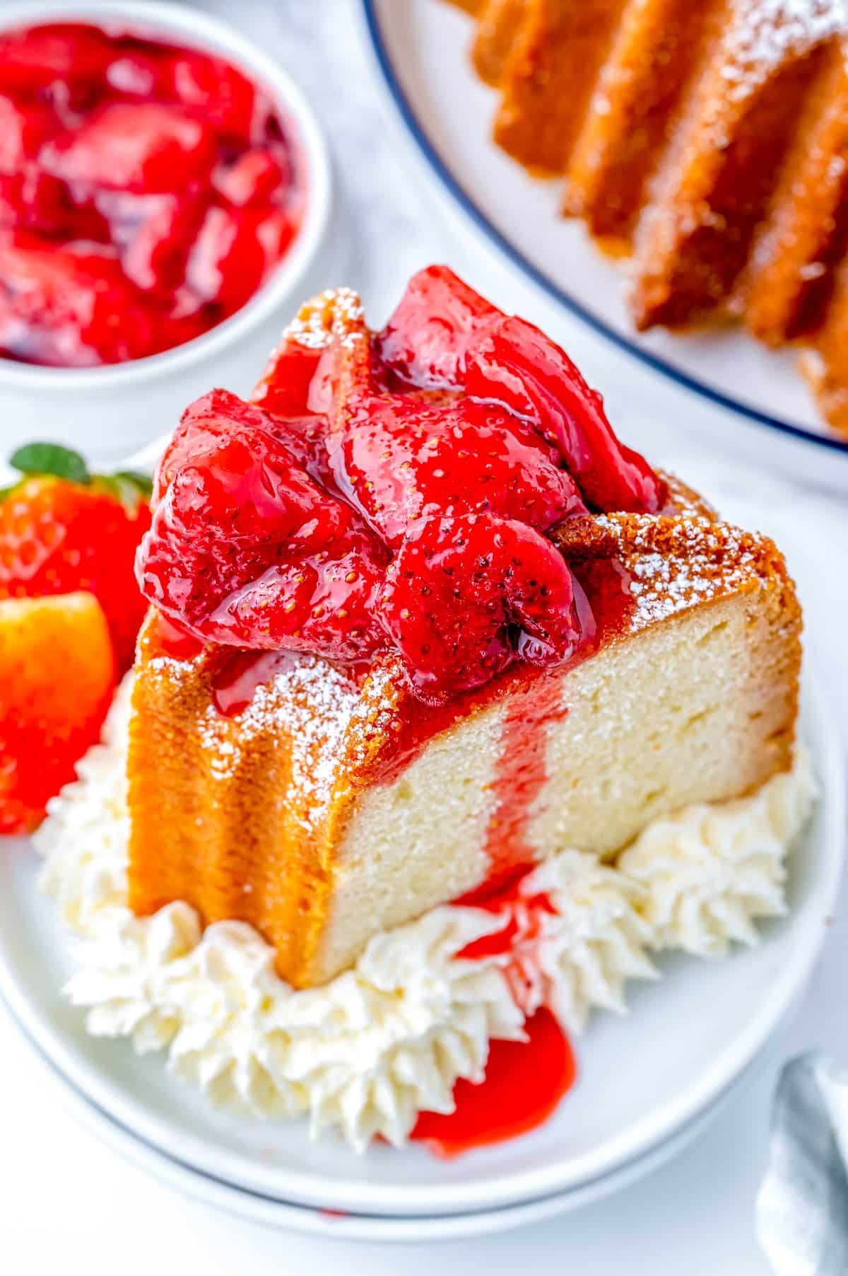 An overhead picture of a piece of Cream Cheese Pound Cake with strawberry topping on it.