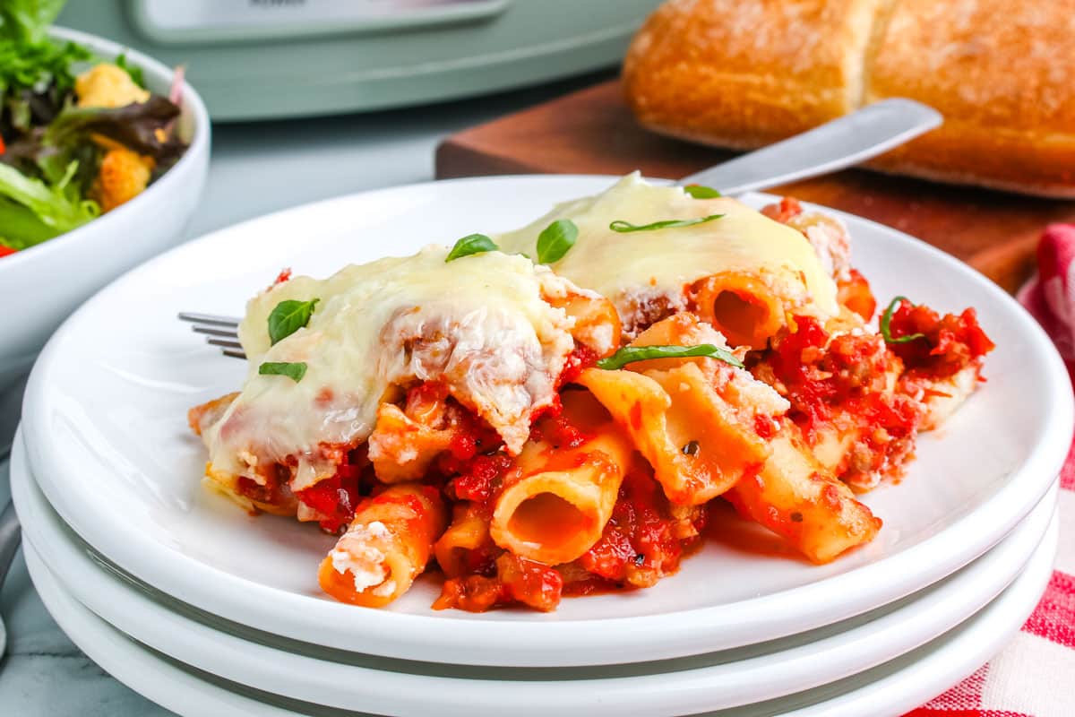 A scoop of baked ziti on a white plate.