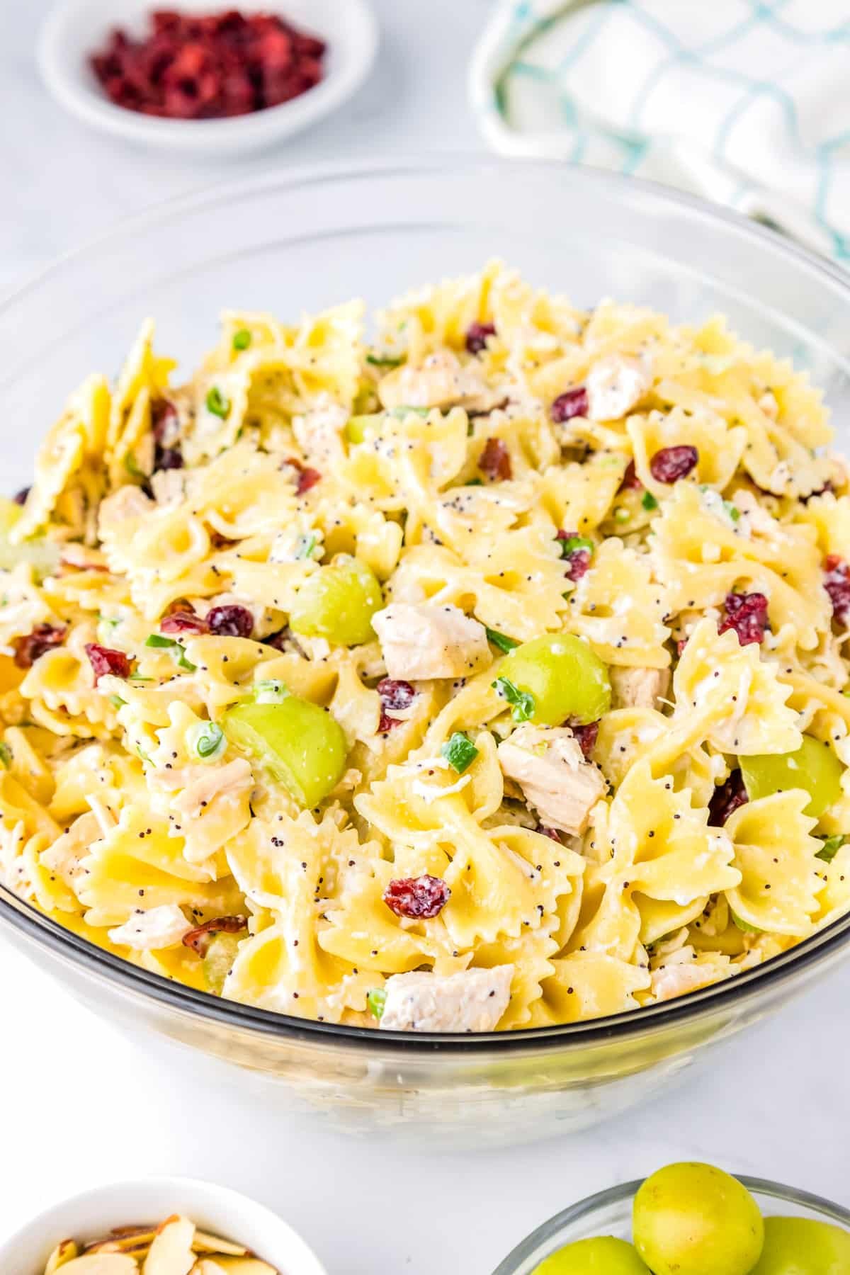 Chicken pasta salad with grapes in a clear serving bowl.
