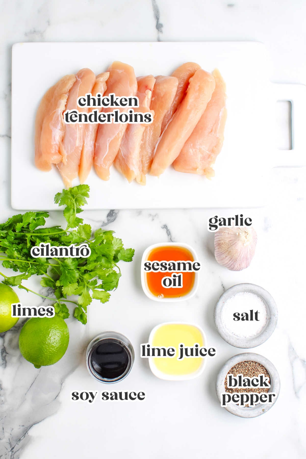 Ingredients for cilantro chicken including chicken tenderloins, fresh cilantro, garlic, lime, soy sauce, sesame oil, salt, and pepper.