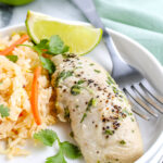 Easy cilantro chicken served with rice pilaf and lime wedges.