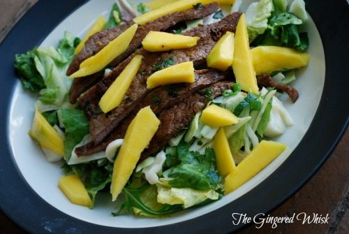 Grilled Asian Flank Steak mango salad in a bowl
