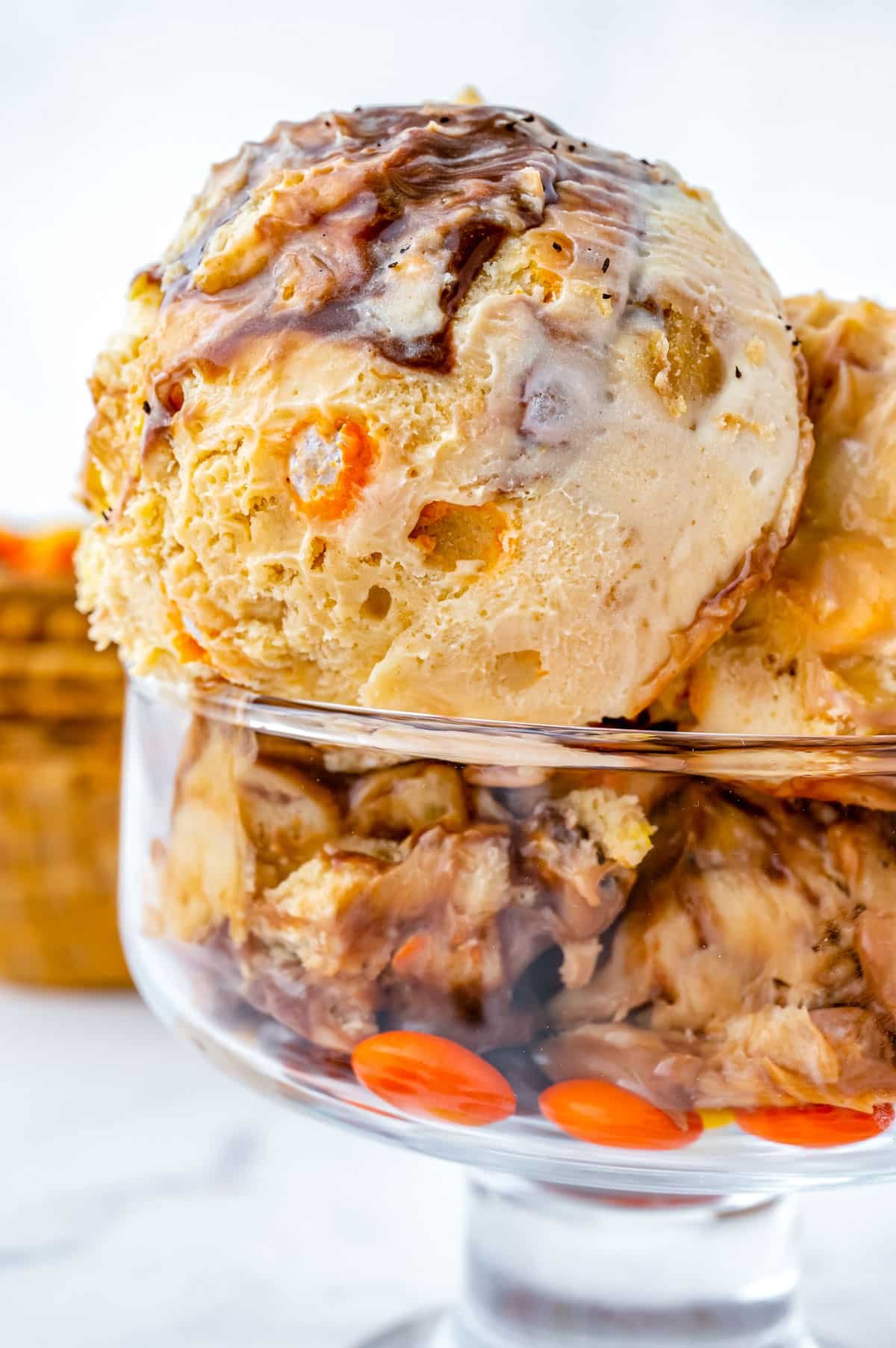 A close up picture of scoops of Reese's Ice Cream in a glass bowl.