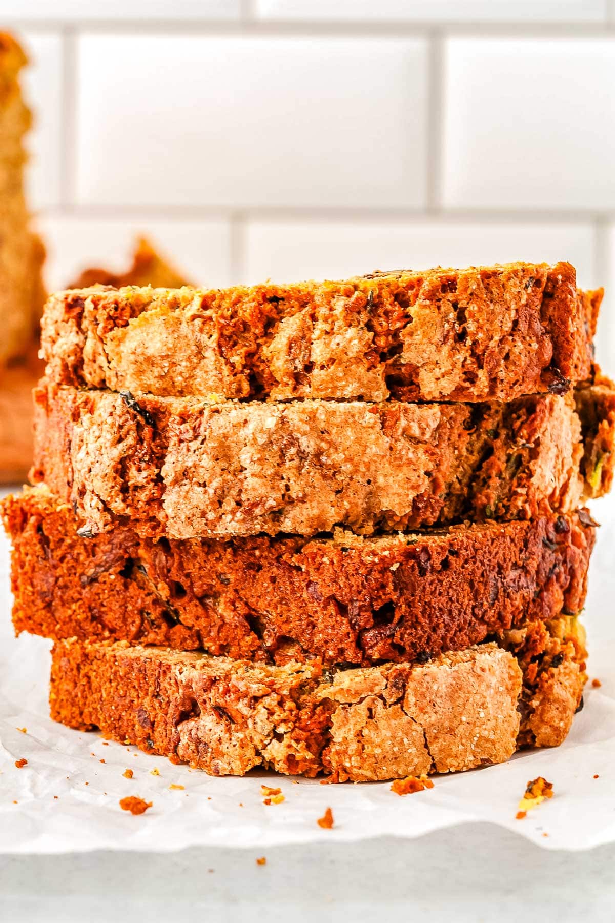 Four slices of Zucchini Bread stacked on top of each other.