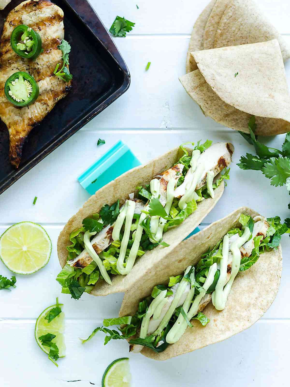 Two garlic-lime grilled chicken in taco holders