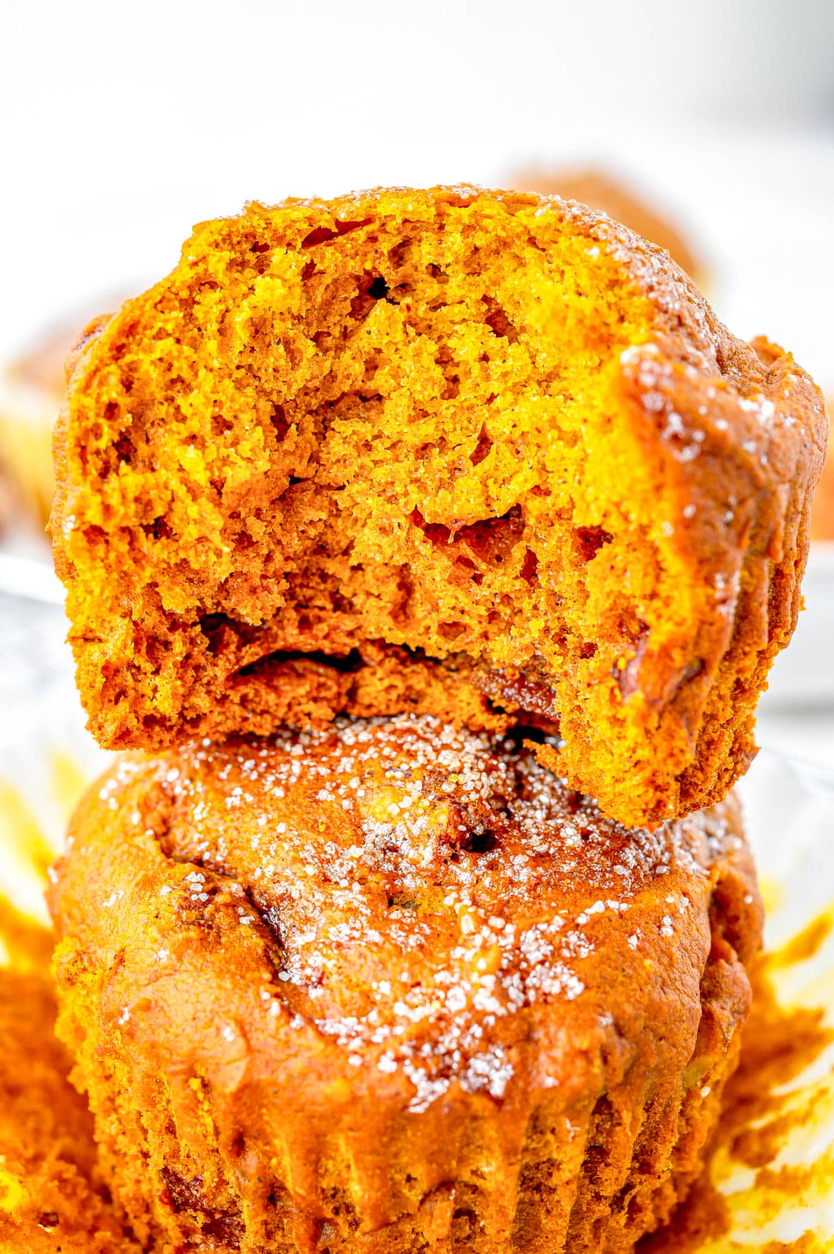 Two Pumpkin Muffins stacked on top of each other.