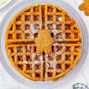 A close up picture of the finished Gingerbread Waffle recipe on a white plate.